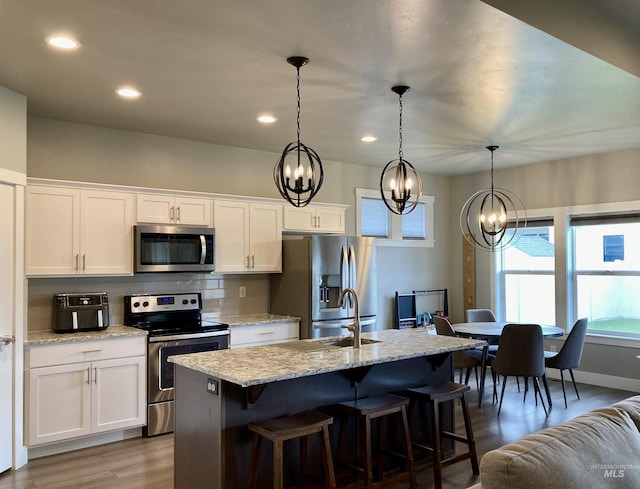 1983 Prospector Way, Twin Falls, ID 83301 - kitchen with stainless steel appliances, a chandelier, a sink, white cabinetry, and recessed lighting