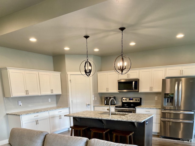 1983 Prospector Way, Twin Falls, ID 83301 - kitchen with stainless steel appliances, backsplash, white cabinetry, and recessed lighting