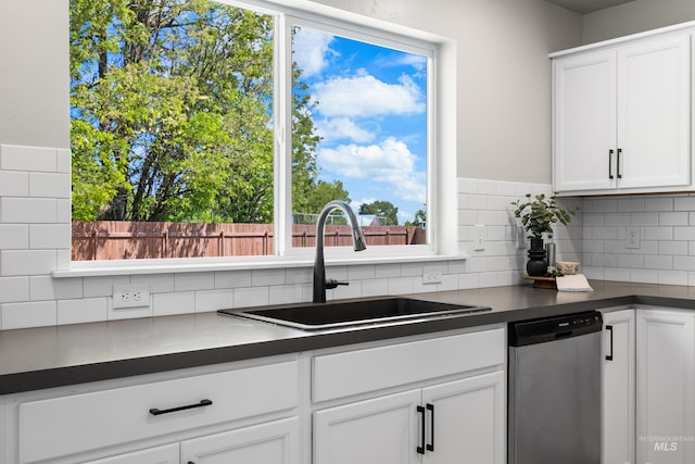 19920 Lenape Ct, Caldwell, ID 83605 - kitchen with stainless steel dishwasher, a sink, dark countertops, tasteful backsplash, and white cabinetry