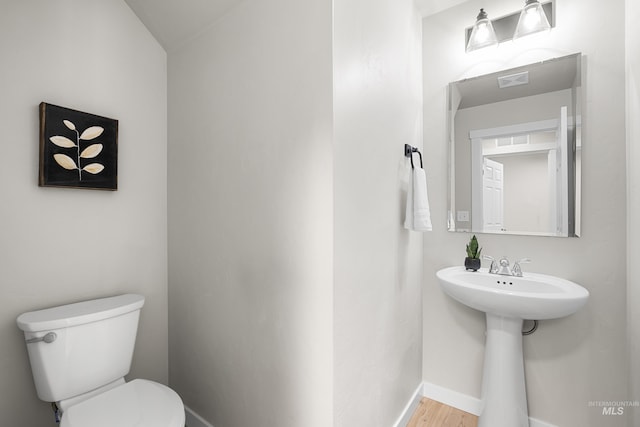 19920 Lenape Ct, Caldwell, ID 83605 - bathroom featuring toilet, baseboards, and wood finished floors