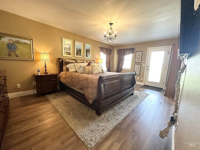 3195 N 3526e, Kimberly, ID 83341 - bedroom featuring wood finished floors, a chandelier, baseboards, and a textured ceiling