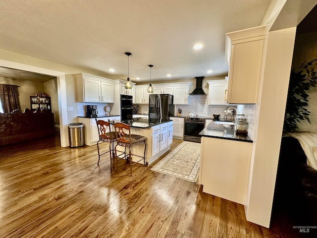 3195 N 3526e, Kimberly, ID 83341 - kitchen with black appliances, wall chimney range hood, dark countertops, a sink, and wood finished floors