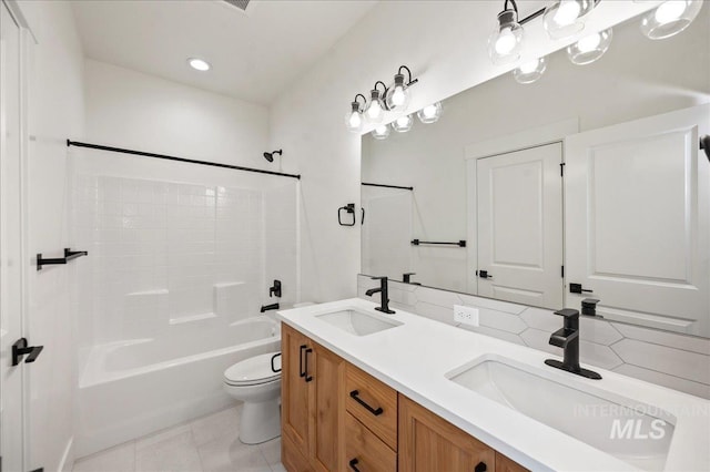 full bathroom featuring tile patterned flooring, vanity, toilet, and tub / shower combination