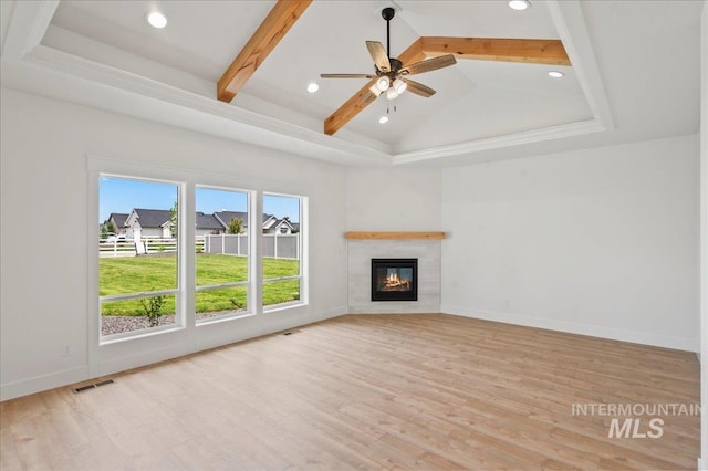 unfurnished living room with vaulted ceiling with beams, light wood-type flooring, and ceiling fan