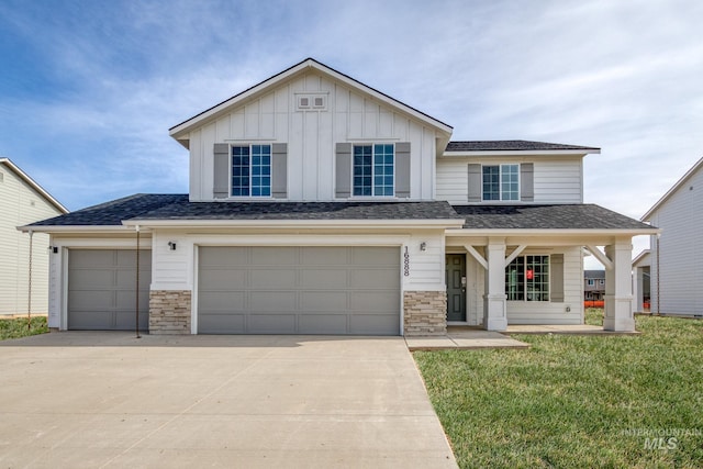 16888 Dunning Way, Caldwell, ID 83607 - traditional home featuring a front lawn, board and batten siding, driveway, stone siding, and a garage