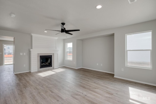 16888 Dunning Way, Caldwell, ID 83607 - unfurnished living room with a fireplace, light wood-style floors, baseboards, and ceiling fan