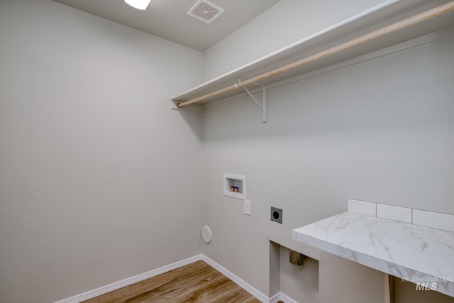 16888 Dunning Way, Caldwell, ID 83607 - laundry area with electric dryer hookup, laundry area, light wood-style flooring, visible vents, and washer hookup