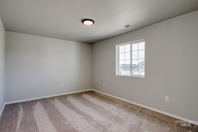 16888 Dunning Way, Caldwell, ID 83607 - carpeted empty room with baseboards, visible vents, and a textured ceiling