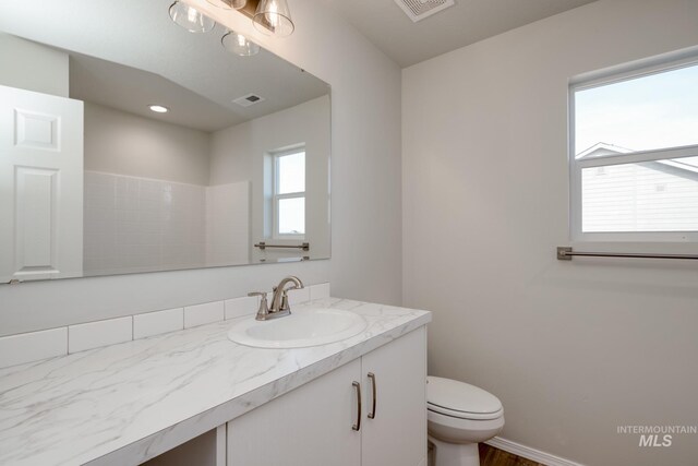 16888 Dunning Way, Caldwell, ID 83607 - bathroom featuring toilet, vanity, and visible vents