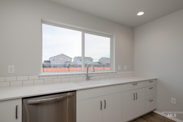 16888 Dunning Way, Caldwell, ID 83607 - kitchen with plenty of natural light, stainless steel dishwasher, a sink, and backsplash