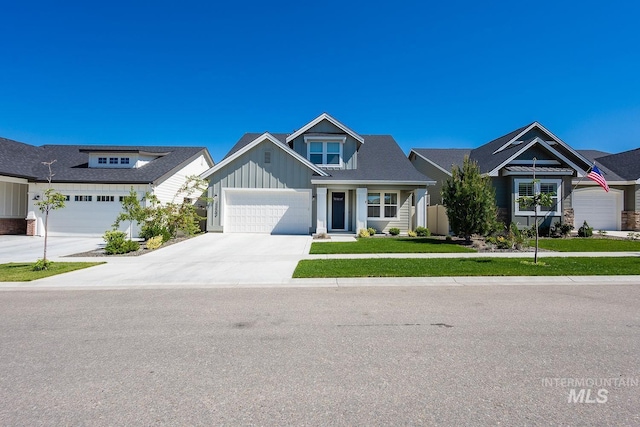 11706 W Lilium St, Star, ID 83669 - view of front facade featuring board and batten siding, concrete driveway, a garage, and a front lawn