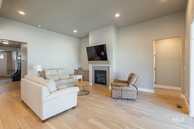 11706 W Lilium St, Star, ID 83669 - living room featuring light wood-type flooring, a fireplace, and recessed lighting