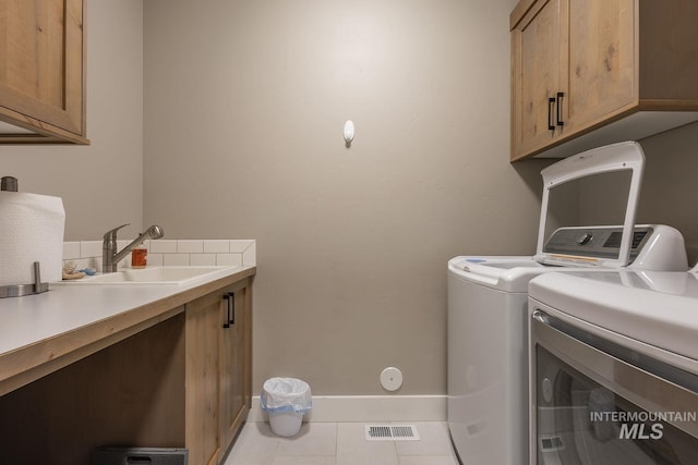 11706 W Lilium St, Star, ID 83669 - laundry room with separate washer and dryer, cabinet space, and tile patterned flooring