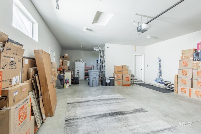 11706 W Lilium St, Star, ID 83669 - garage with a garage door opener and freestanding refrigerator