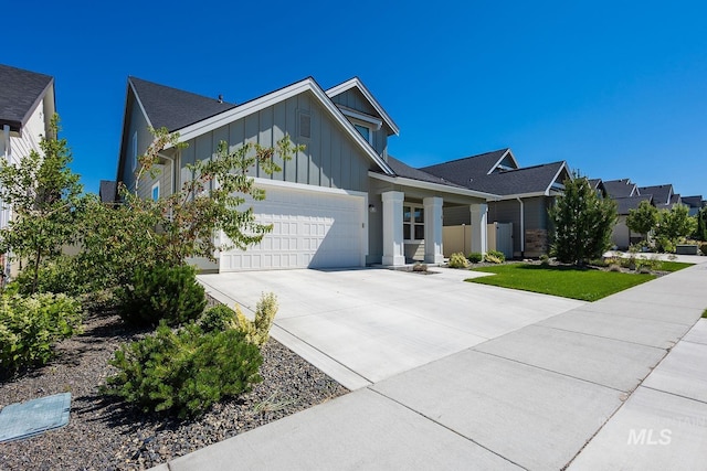 11706 W Lilium St, Star, ID 83669 - view of front of house featuring board and batten siding, an attached garage, and concrete driveway
