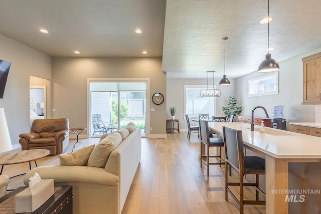 11706 W Lilium St, Star, ID 83669 - living area featuring light wood-type flooring, recessed lighting, and a textured ceiling