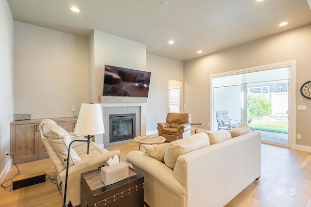 11706 W Lilium St, Star, ID 83669 - living room featuring light wood-style floors, recessed lighting, and a tile fireplace