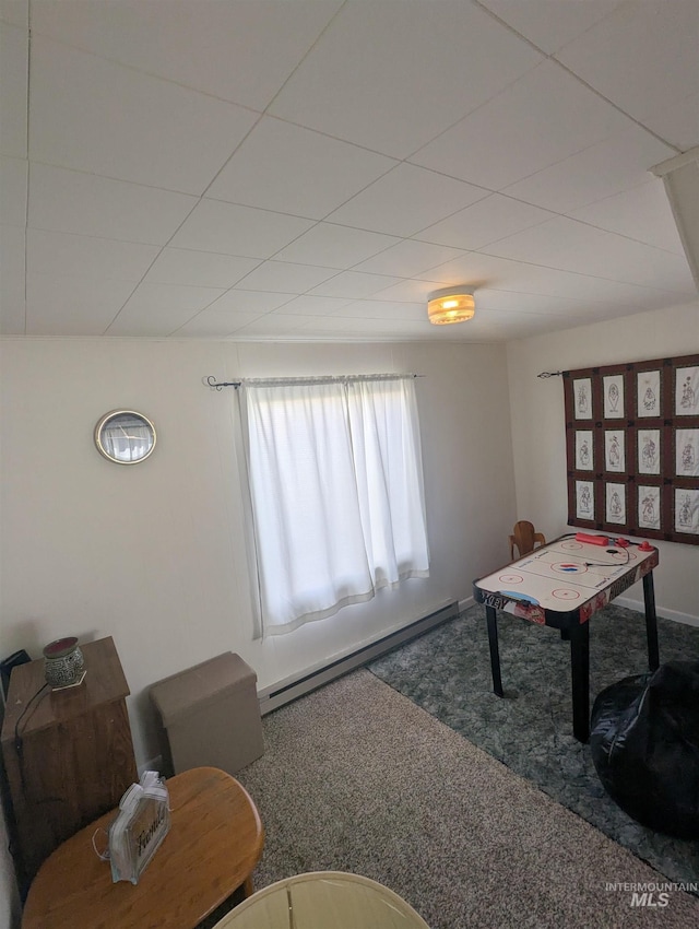 231 Willow Ave E, Fairfield, ID 83327 - carpeted living area featuring baseboards and a baseboard heating unit