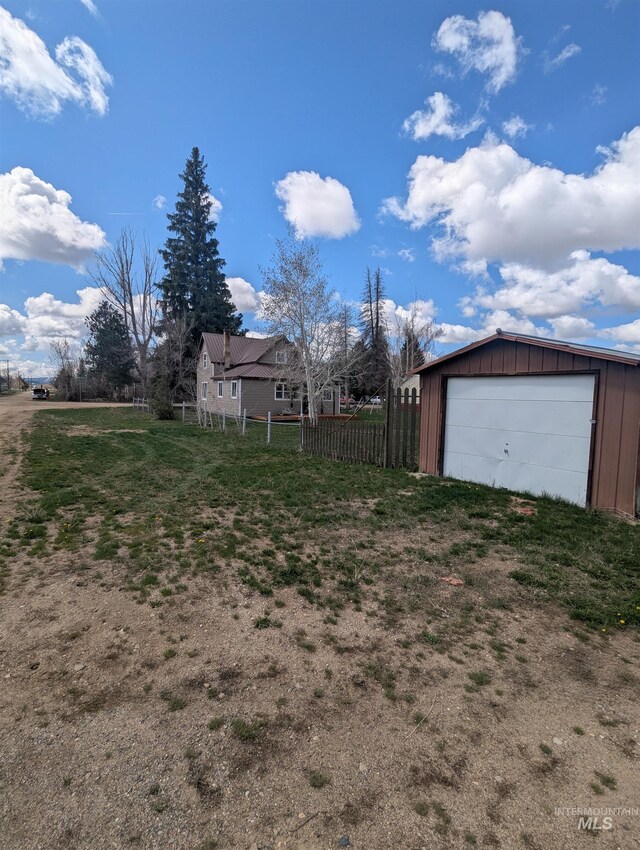 231 Willow Ave E, Fairfield, ID 83327 - view of yard featuring fence, an outbuilding, and a garage