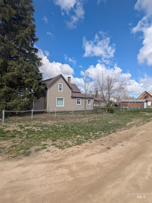 231 Willow Ave E, Fairfield, ID 83327 - view of property exterior with fence and a chimney