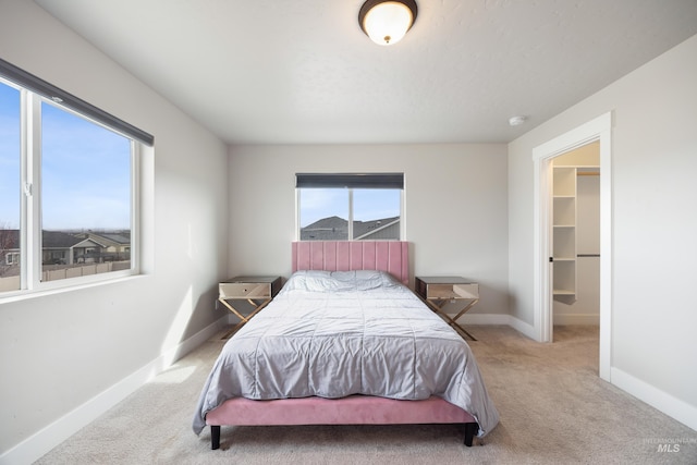 bedroom with carpet and baseboards