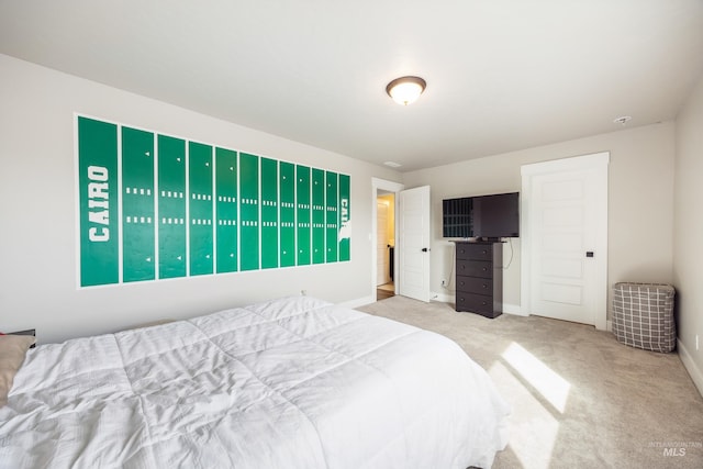 carpeted bedroom featuring baseboards