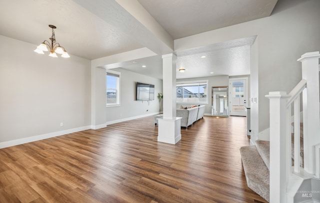 foyer entrance featuring dark wood finished floors, recessed lighting, stairway, an inviting chandelier, and baseboards