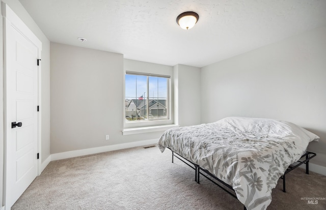 bedroom with visible vents, baseboards, and carpet floors