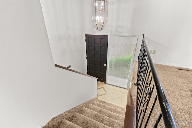 interior space featuring carpet floors and a notable chandelier