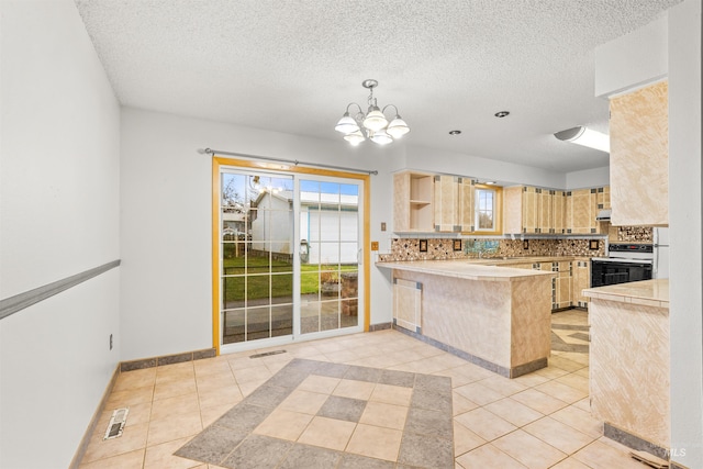 kitchen with light brown cabinets, a textured ceiling, white electric range oven, a kitchen bar, and kitchen peninsula