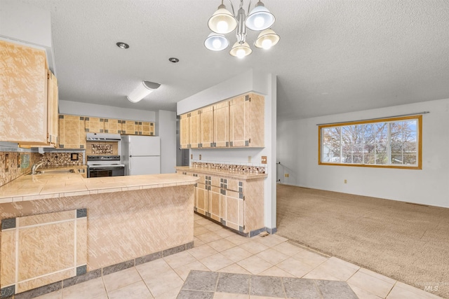 kitchen featuring light carpet, light brown cabinetry, kitchen peninsula, white appliances, and pendant lighting