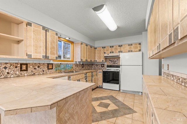 kitchen featuring kitchen peninsula, decorative backsplash, a textured ceiling, white appliances, and light tile patterned flooring