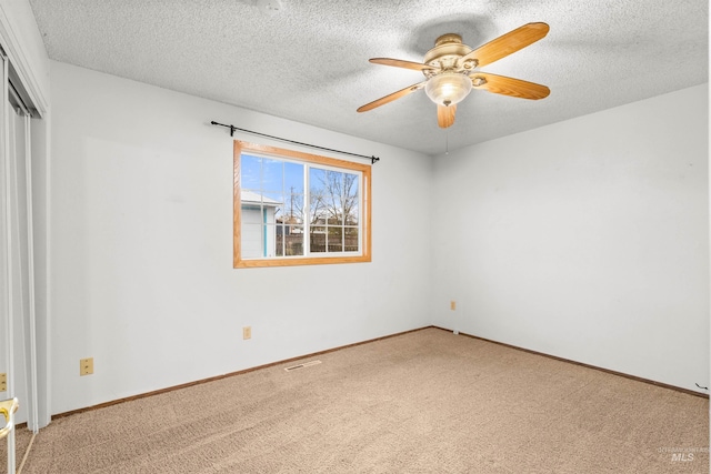 unfurnished bedroom with carpet flooring, ceiling fan, and a textured ceiling