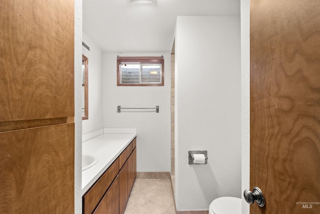 bathroom featuring tile patterned floors, vanity, and toilet