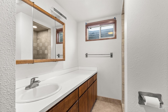 bathroom with tile patterned flooring and vanity