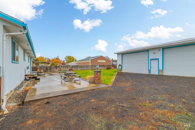 view of yard with a garage and a patio