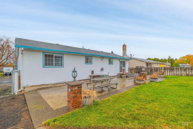 rear view of house with a lawn, area for grilling, and a patio