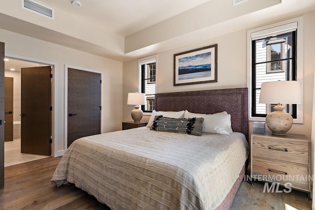 bedroom featuring dark hardwood / wood-style flooring