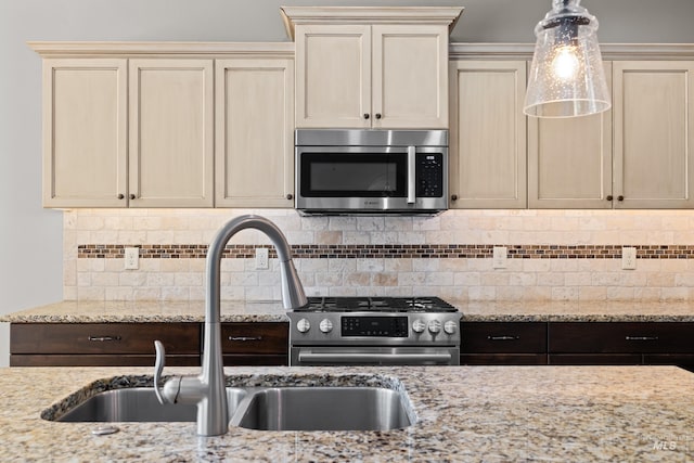 168 S Tresa Ave, Star, ID 83669 - kitchen featuring stainless steel appliances, a sink, cream cabinets, and light stone countertops