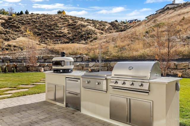 view of patio / terrace with an outdoor kitchen and a grill