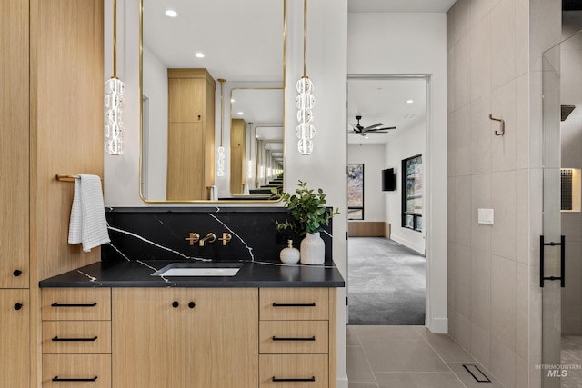 bathroom with tile patterned flooring, vanity, ceiling fan, and a shower with shower door