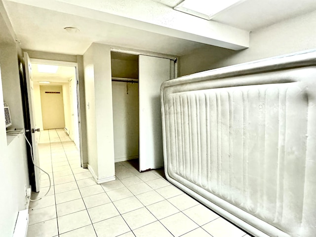 unfurnished bedroom featuring light tile patterned flooring and a closet