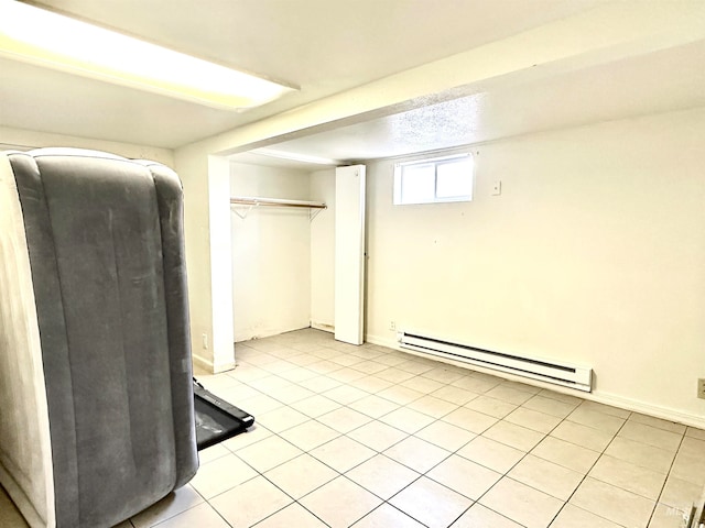 interior space featuring a baseboard heating unit and light tile patterned floors