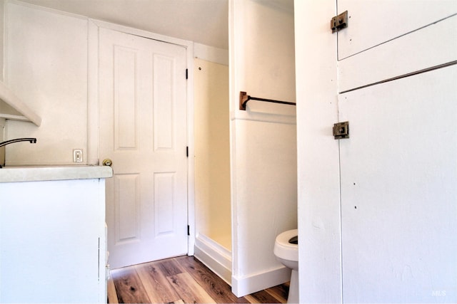 2912 S Harmony Ave, Boise, ID 83706 - bathroom featuring wood finished floors, toilet, and baseboards