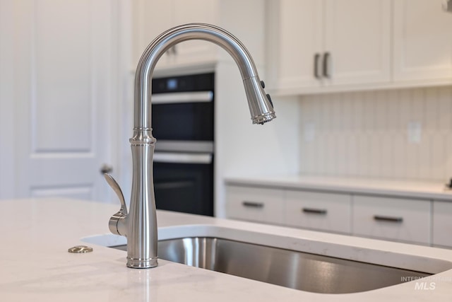 room details with light stone counters and white cabinetry