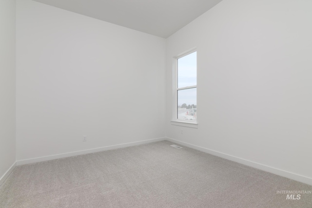 carpeted empty room with baseboards and visible vents
