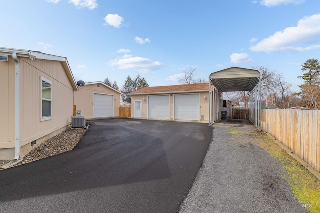 exterior space featuring a carport, cooling unit, and fence