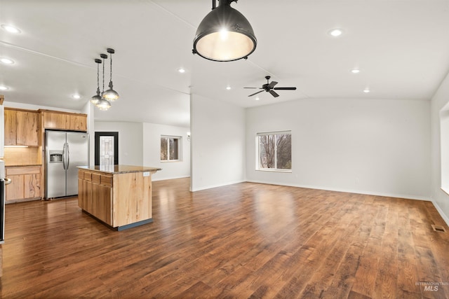 kitchen featuring lofted ceiling, dark hardwood / wood-style flooring, hanging light fixtures, a center island, and stainless steel fridge with ice dispenser