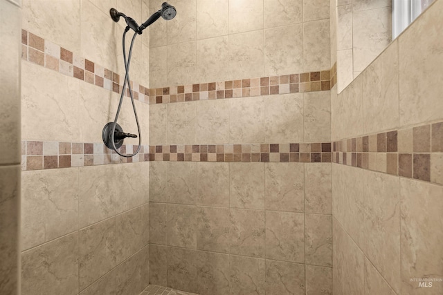 interior details with a tile shower