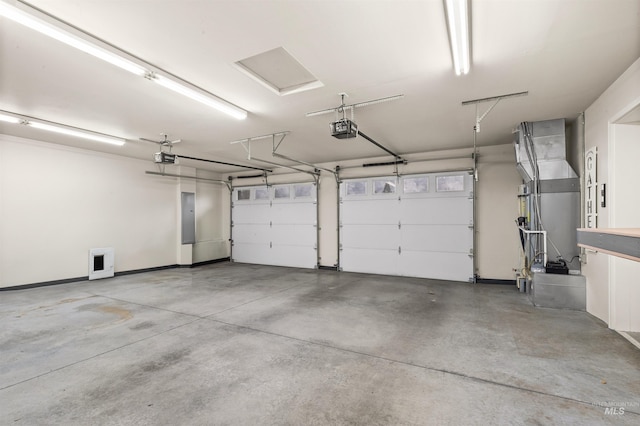 garage with a garage door opener and electric panel